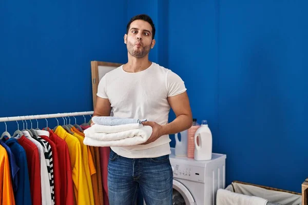 Young Hispanic Man Beard Holding Folded Clean Towels Laundry Room — Zdjęcie stockowe