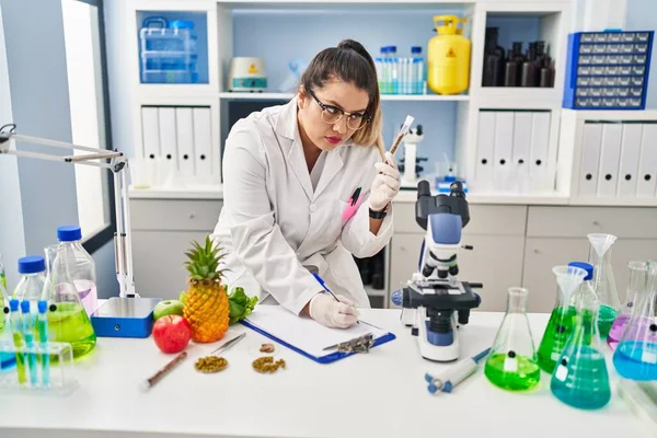 Young Beautiful Size Woman Scientist Writing Report Holding Test Tube — Photo
