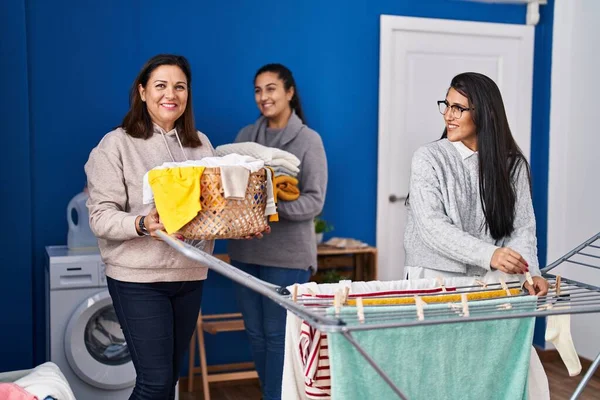 Three Woman Smiling Confident Hanging Clothes Clothesline Laundry Room — Fotografia de Stock