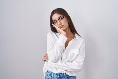 Young brunette woman wearing glasses thinking looking tired and bored with depression problems with crossed arms. 