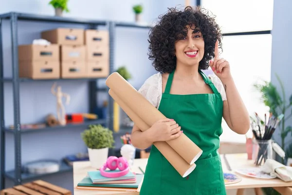 Young Brunette Woman Curly Hair Holding Paper Blueprints Surprised Idea — Stockfoto