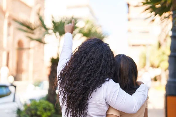 Mother Daughter Hugging Each Other Pointing Finger Sky Park — Stockfoto