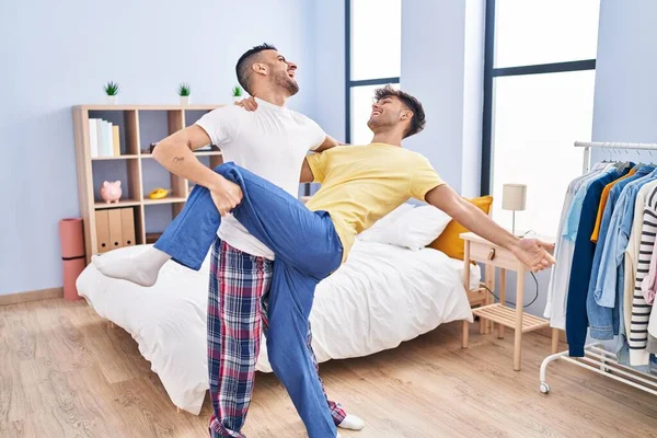 Two man couple dancing at bedroom