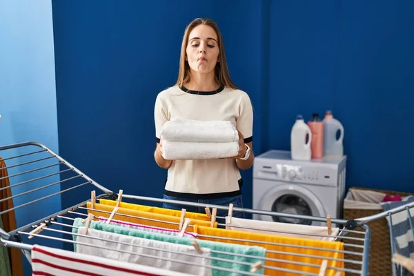 Young Woman Holding Clean Laundry Clothesline Making Fish Face Mouth — Stockfoto