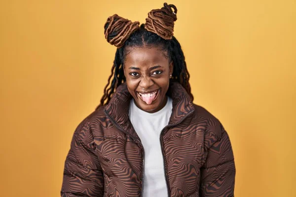 African Woman Braided Hair Standing Yellow Background Sticking Tongue Out — ストック写真