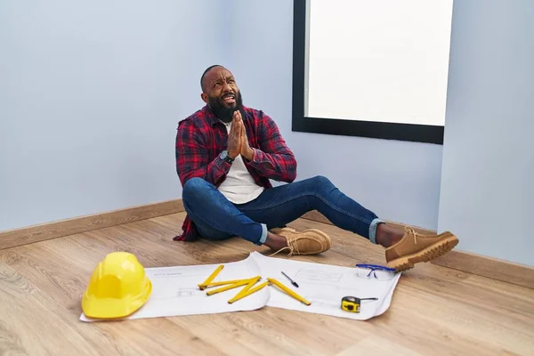 African American Man Sitting Floor New Home Looking Blueprints Begging — Foto de Stock