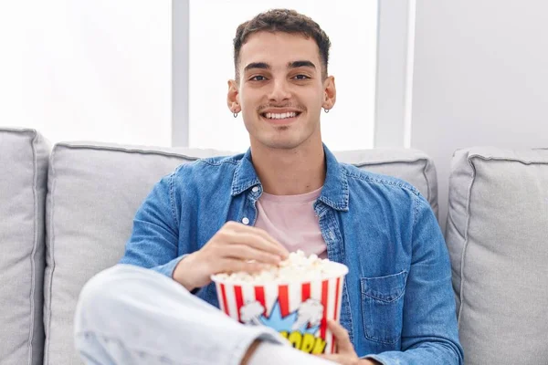 Young Hispanic Man Watching Movie Sitting Sofa Home — Stockfoto