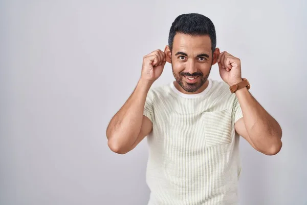 Hispanic Man Beard Standing Isolated Background Smiling Pulling Ears Fingers — Stock fotografie