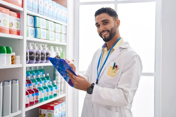 Young Arab Man Pharmacist Smiling Confident Writing Clipboard Pharmacy — Stock Photo, Image