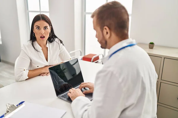 Young Hispanic Woman Doctor Scared Amazed Open Mouth Surprise Disbelief — Stockfoto
