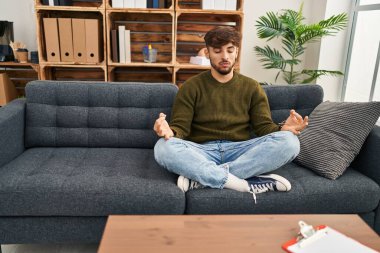Young arab man patient having yoga exercise at psychology center