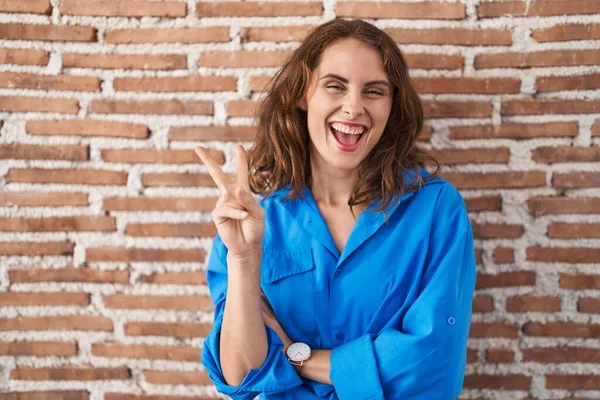 Beautiful Brunette Woman Standing Bricks Wall Smiling Happy Face Winking — Stock Photo, Image