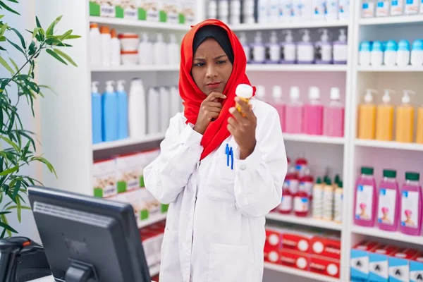 Young Beautiful Woman Pharmacist Using Computer Holding Pills Bottle Pharmacy — Zdjęcie stockowe