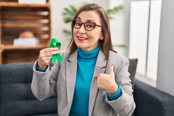 Middle Age Hispanic Woman Holding Support Green Ribbon Pointing Finger — Stock Photo, Image