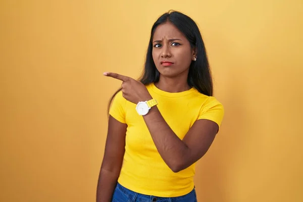 Young Indian Woman Standing Yellow Background Pointing Aside Worried Nervous — 图库照片