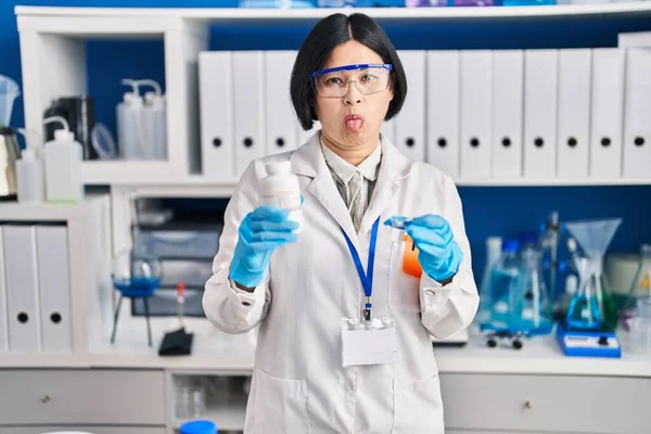 Young Asian Woman Working Scientist Laboratory Sticking Tongue Out Happy — Stockfoto
