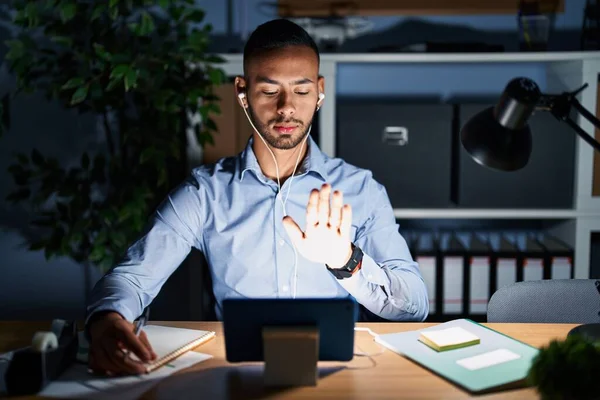 Young Hispanic Man Working Office Night Doing Stop Sing Palm — Stok fotoğraf