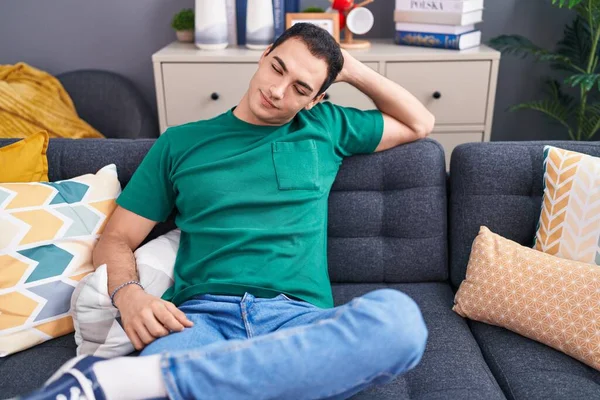 Young Hispanic Man Relaxed Hand Head Sitting Sofa Home — Stockfoto
