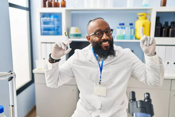 African American Man Working Scientist Laboratory Holding Syringe Surprised Idea — Zdjęcie stockowe