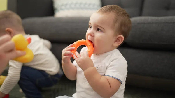 Adorable Toddler Bitting Plastic Hoop Sitting Floor Home —  Fotos de Stock