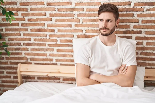 Young Caucasian Man Sitting Bed Unhappy Expression Arms Crossed Gesture — Stock Photo, Image