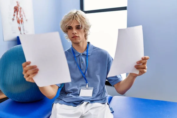 Young Blond Man Pysiotherapist Reading Document Sitting Massage Board Rehab — Stock Photo, Image