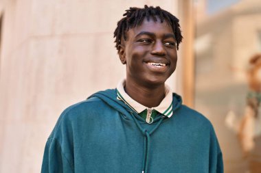 African american man smiling confident looking to the side at street