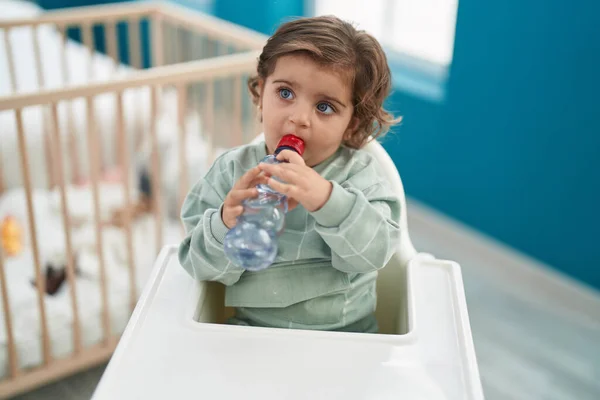 Adorable Hispanic Girl Sitting Baby Highchair Drinking Water Bedroom — Stock Photo, Image