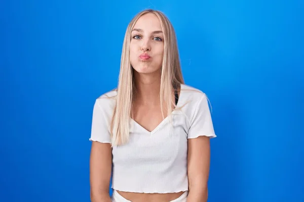 Young Caucasian Woman Standing Blue Background Puffing Cheeks Funny Face —  Fotos de Stock