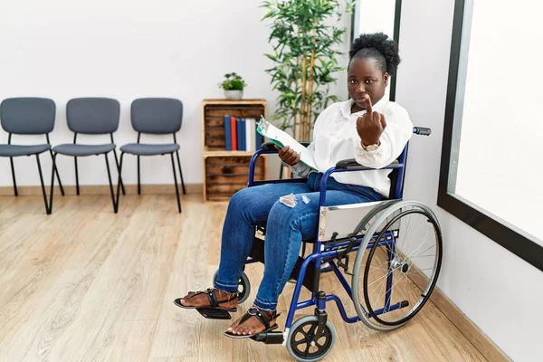 Young Black Woman Sitting Wheelchair Waiting Room Showing Middle Finger —  Fotos de Stock