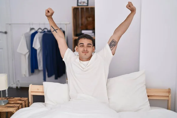 Young Hispanic Man Waking Stretching Arms Bedroom — Fotografie, imagine de stoc