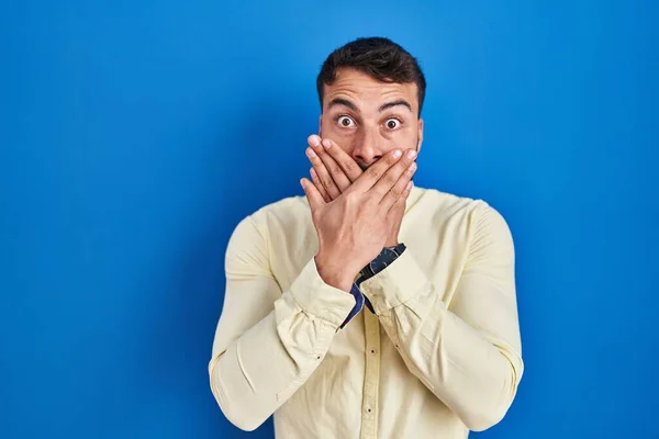 Handsome Hispanic Man Standing Blue Background Shocked Covering Mouth Hands — Stockfoto