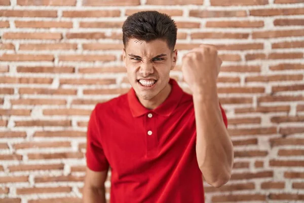 Young Hispanic Man Standing Bricks Wall Angry Mad Raising Fist —  Fotos de Stock
