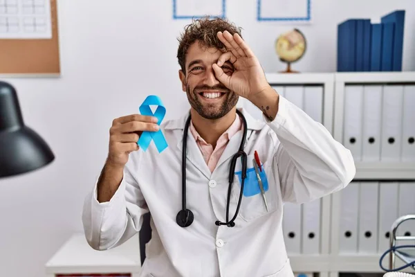 Young Hispanic Doctor Man Holding Blue Ribbon Smiling Happy Doing — Stock Photo, Image