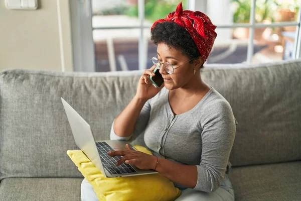 African American Woman Using Laptop Talking Smartphone Home —  Fotos de Stock