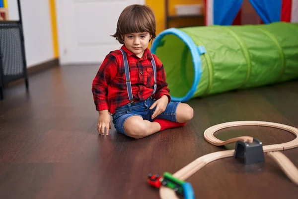 stock image Adorable toddler playing with cars toy sitting on floor at home