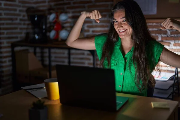 Young Teenager Girl Working Office Night Showing Arms Muscles Smiling — Stockfoto