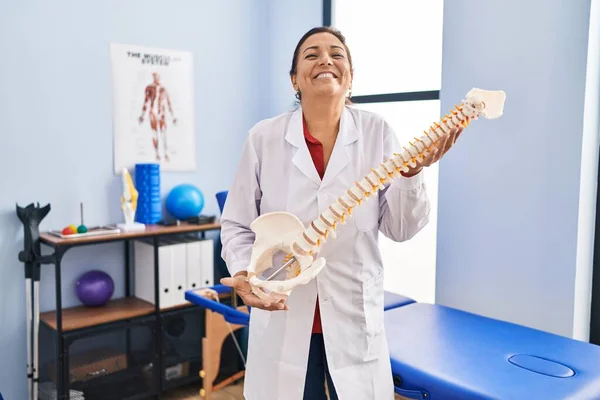 Middle Age Hispanic Woman Holding Anatomical Model Spinal Column Smiling — Foto de Stock