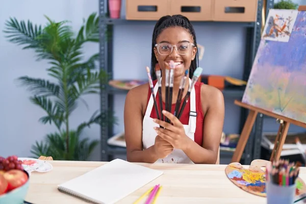 African American Woman Smiling Confident Holding Paintbrushes Art Studio — Stock Photo, Image