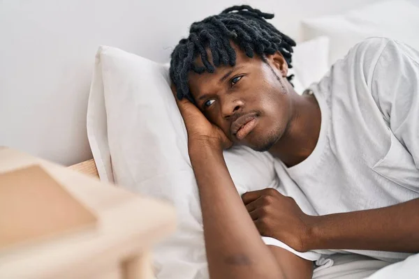 African american man lying on bed at bedroom