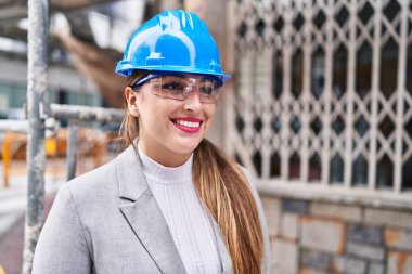 Young beautiful hispanic woman architect smiling confident standing at street
