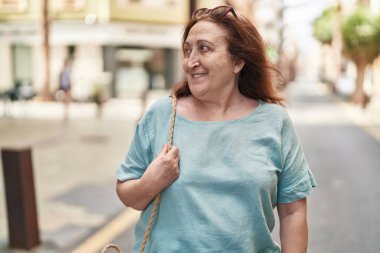 Senior woman smiling confident looking to the side at street