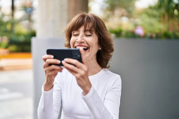 Middle Age Woman Smiling Confident Watching Video Smartphone Street — Stockfoto