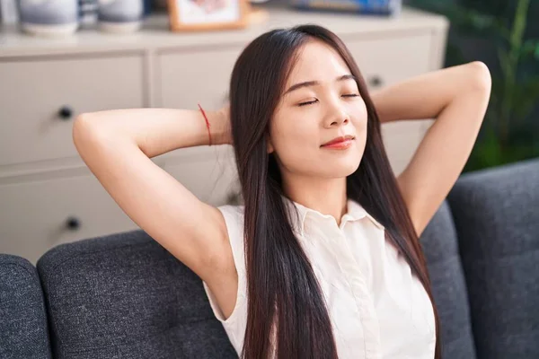 Young Chinese Woman Relaxed Hands Head Sitting Sofa Home — Foto de Stock
