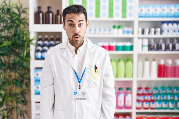 Handsome Hispanic Man Working Pharmacy Drugstore Afraid Shocked Surprise Amazed — Zdjęcie stockowe