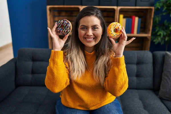 Young Hispanic Woman Eating Doughnuts Home Smiling Happy Cool Smile — Stockfoto
