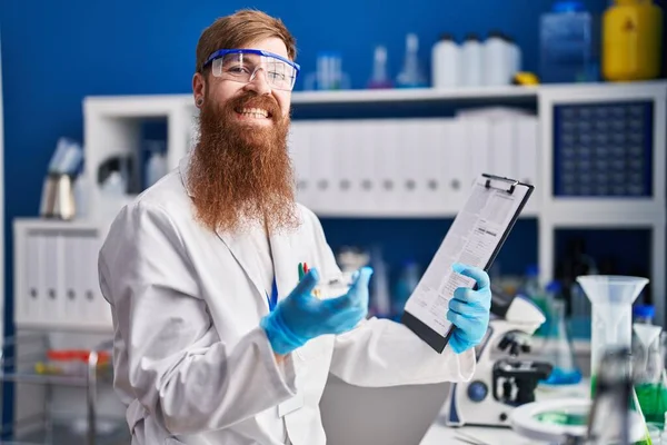 Young Redhead Man Scientist Reading Report Holding Sample Laboratory — Stock Photo, Image