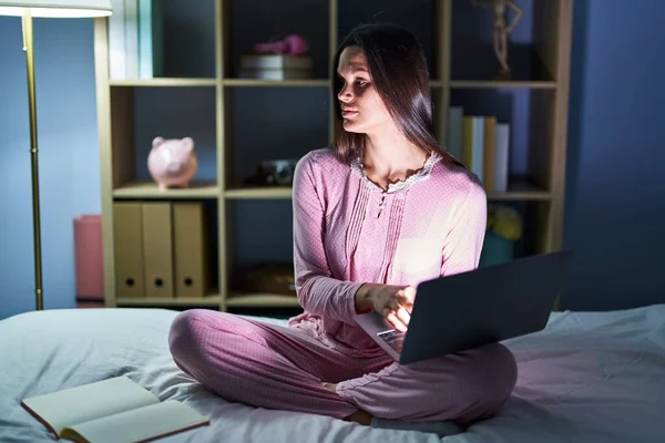Young Hispanic Woman Using Computer Laptop Bed Looking Side Relax —  Fotos de Stock