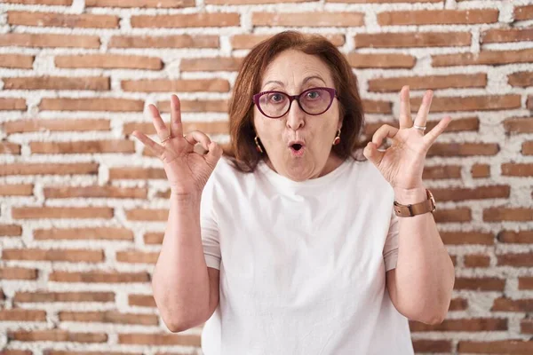 Senior Woman Glasses Standing Bricks Wall Looking Surprised Shocked Doing — Fotografia de Stock