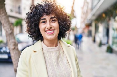 Young middle east woman excutive smiling confident standing at street